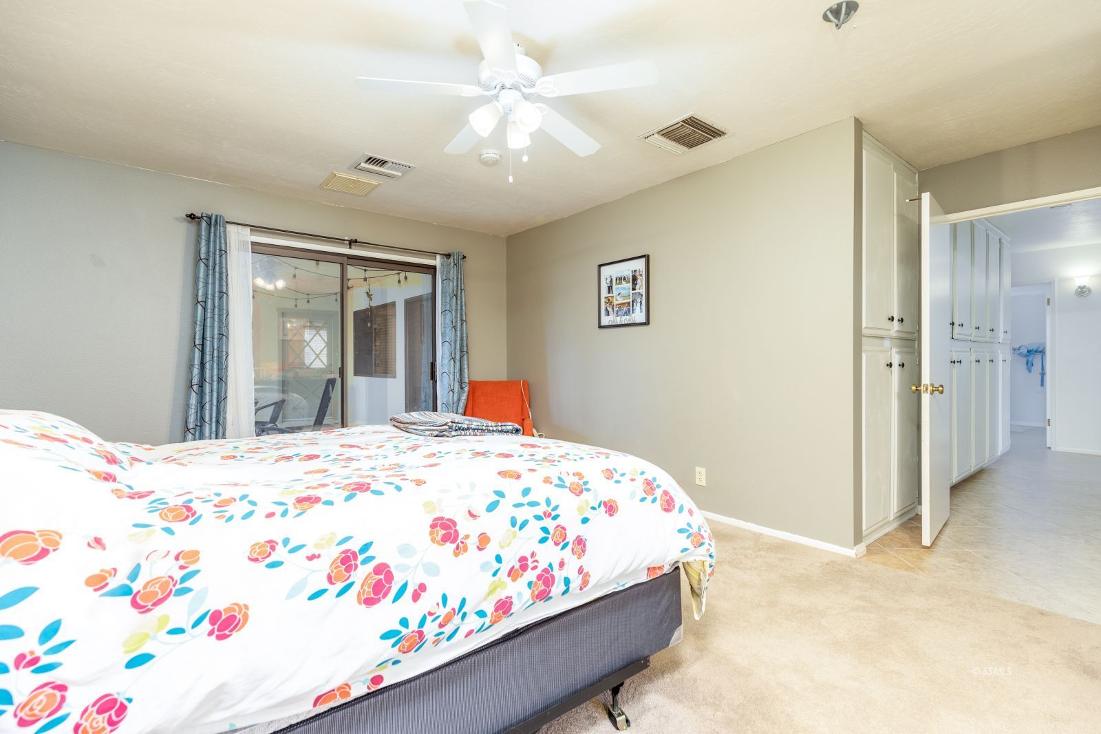 1012 Scott Street Ridgecrest, CA 93555 - Photo 18 of 31 a bedroom with a bed and a chandelier