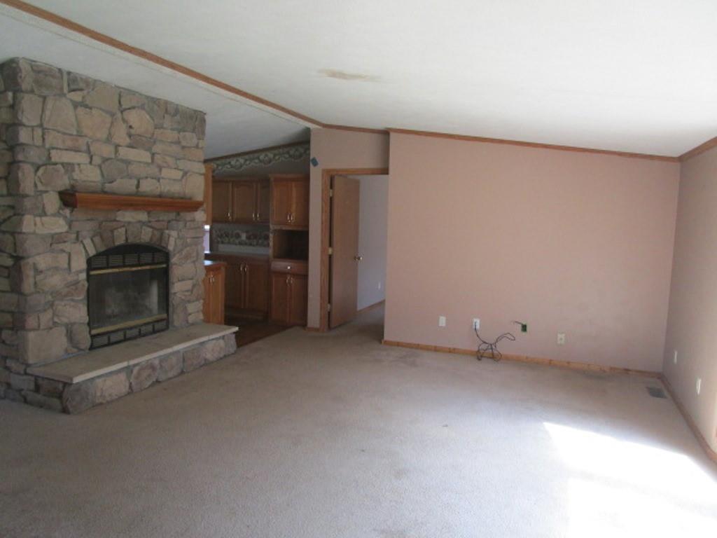 416 Plum Sock Road Prosperity, PA 15329 - Photo 4 of 22 an empty room with a fireplace