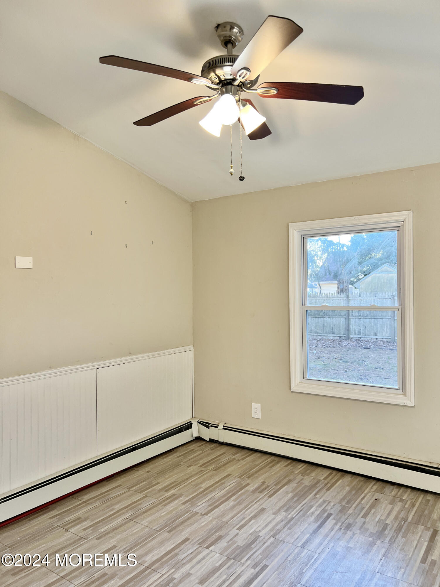 112 Pinehurst Road Brick, NJ 08723 - Photo 4 of 14 an empty room with wooden floor fan and windows