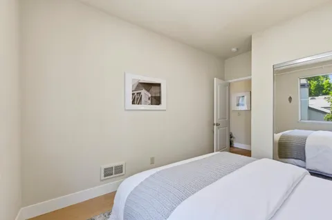 a bedroom with bed and a night stand
