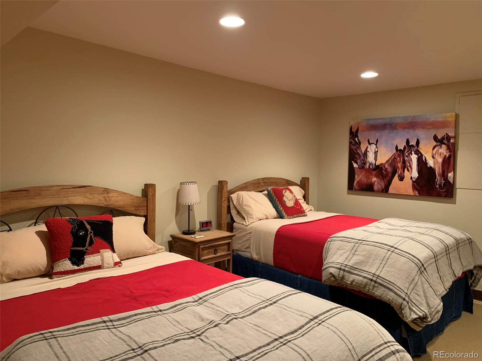 5148 Gore Circle Vail, CO 81657 - Photo 11 of 22 a bedroom with two beds and a painting on the wall