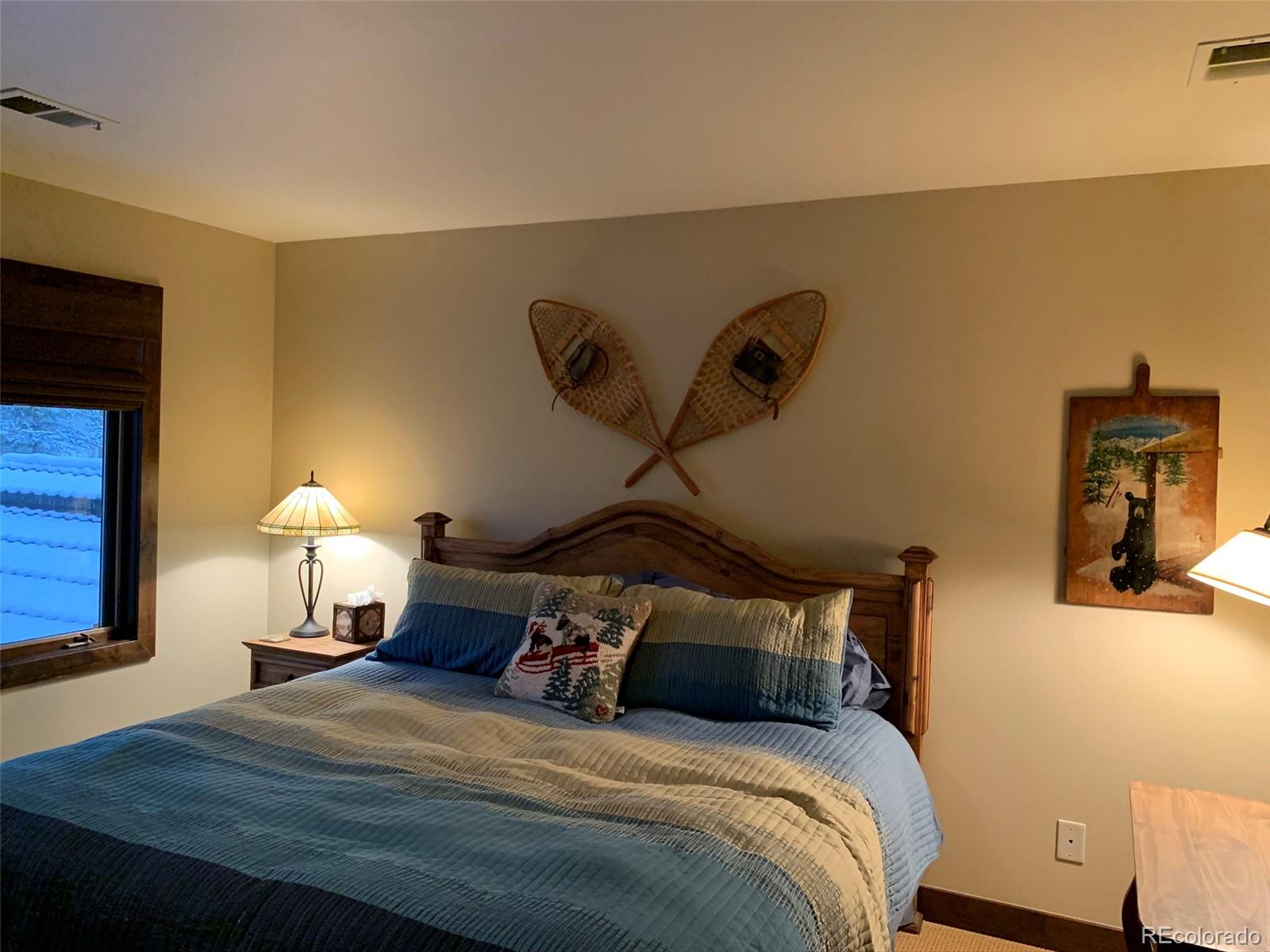 5148 Gore Circle Vail, CO 81657 - Photo 20 of 22 a bedroom with a bed and a lamp on table