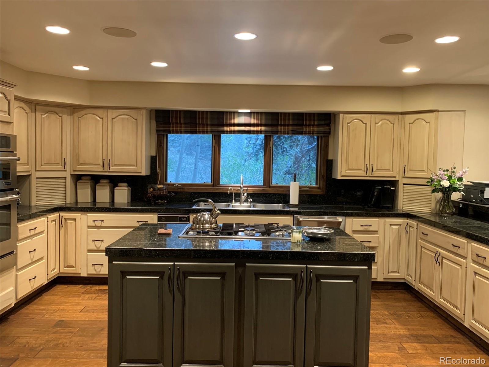 5148 Gore Circle Vail, CO 81657 - Photo 5 of 22 a kitchen with a sink stove and cabinets