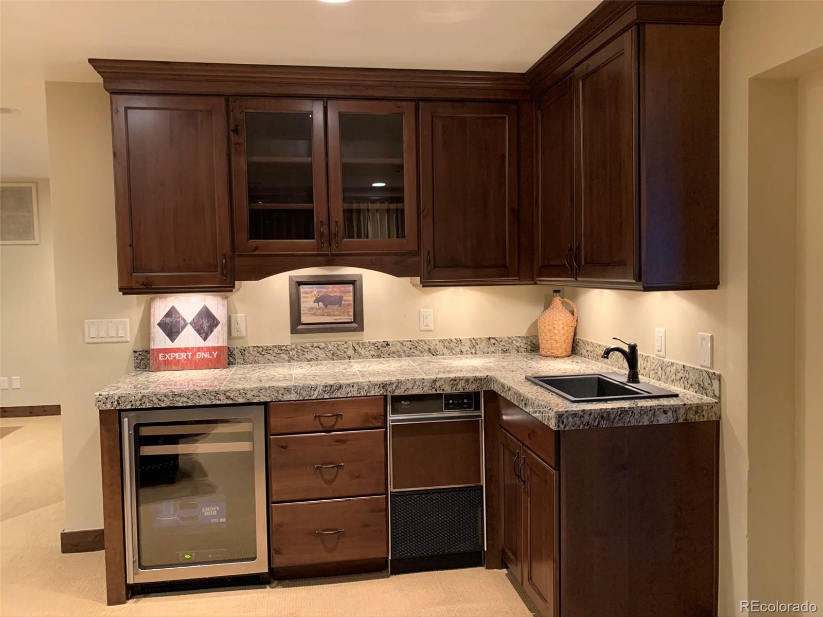 5148 Gore Circle Vail, CO 81657 - Photo 10 of 22 a kitchen with granite countertop a sink and cabinets
