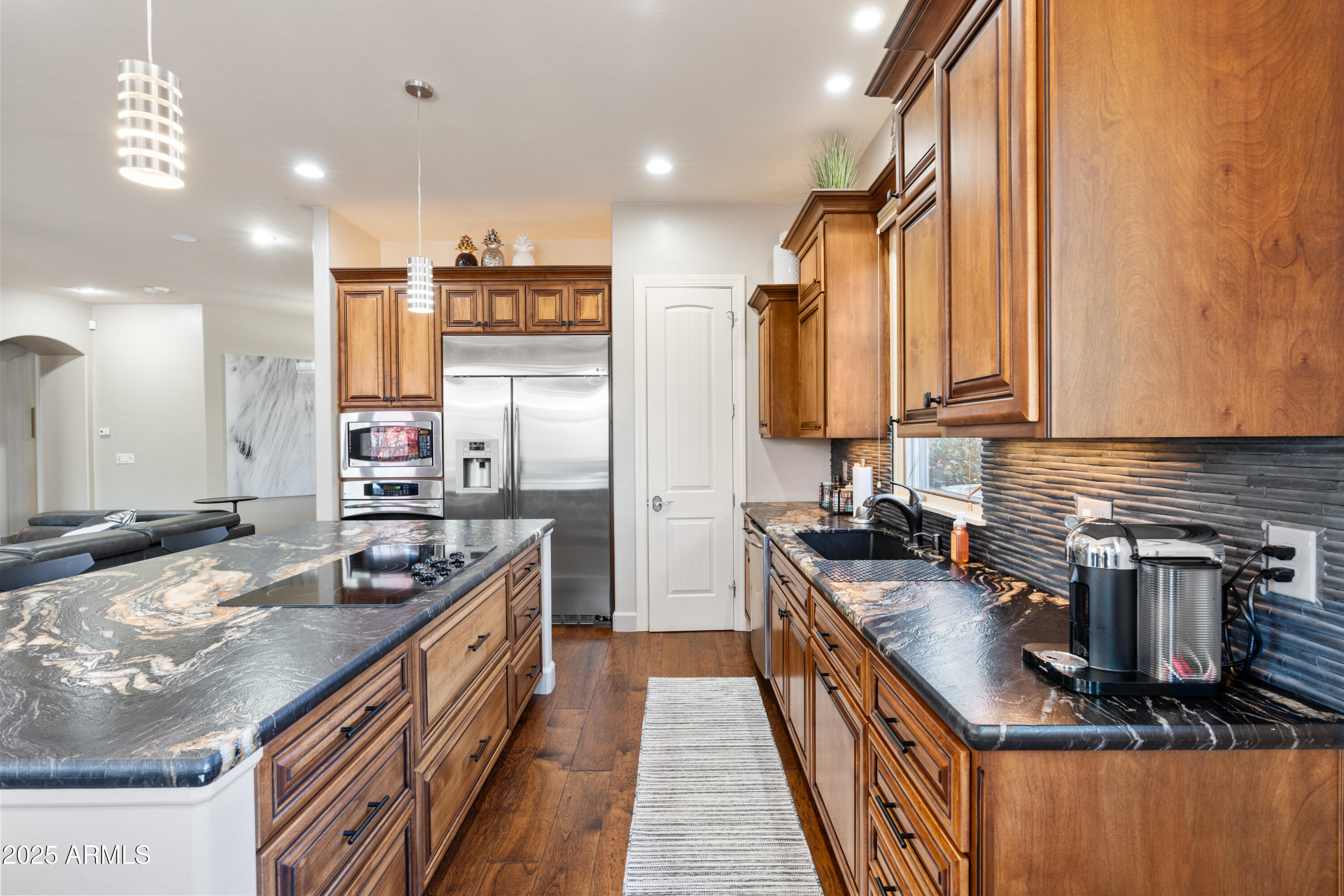 1672 Stable Rock Road Prescott, AZ 86303 - Photo 15 of 47 a kitchen with stainless steel appliances granite countertop a stove top oven a sink dishwasher a dining table and chairs with wooden floor