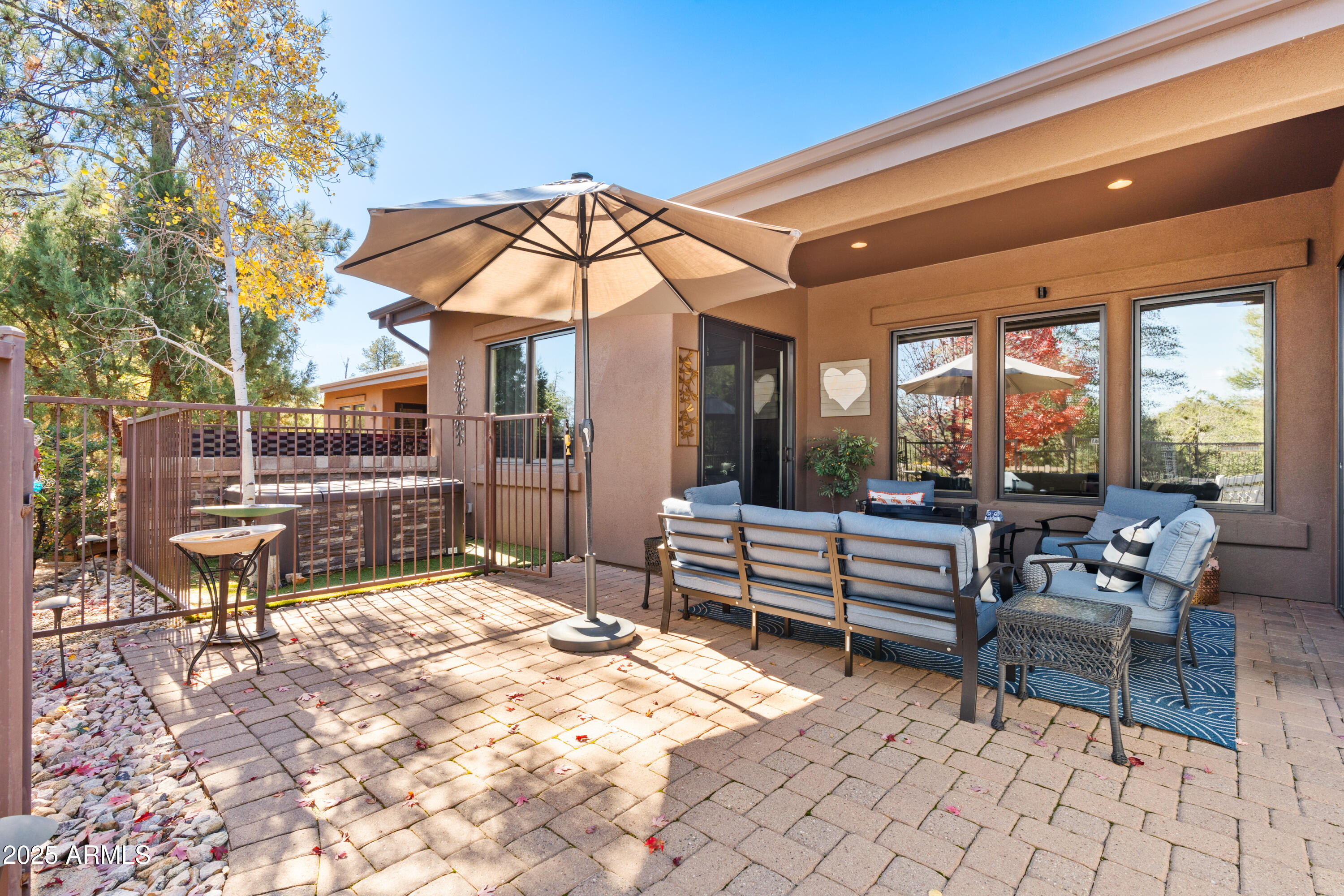 1672 Stable Rock Road Prescott, AZ 86303 - Photo 36 of 47 a patio with a table and chairs under an umbrella