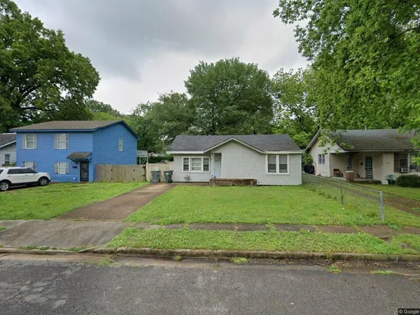 a front view of a house with a yard and a garage