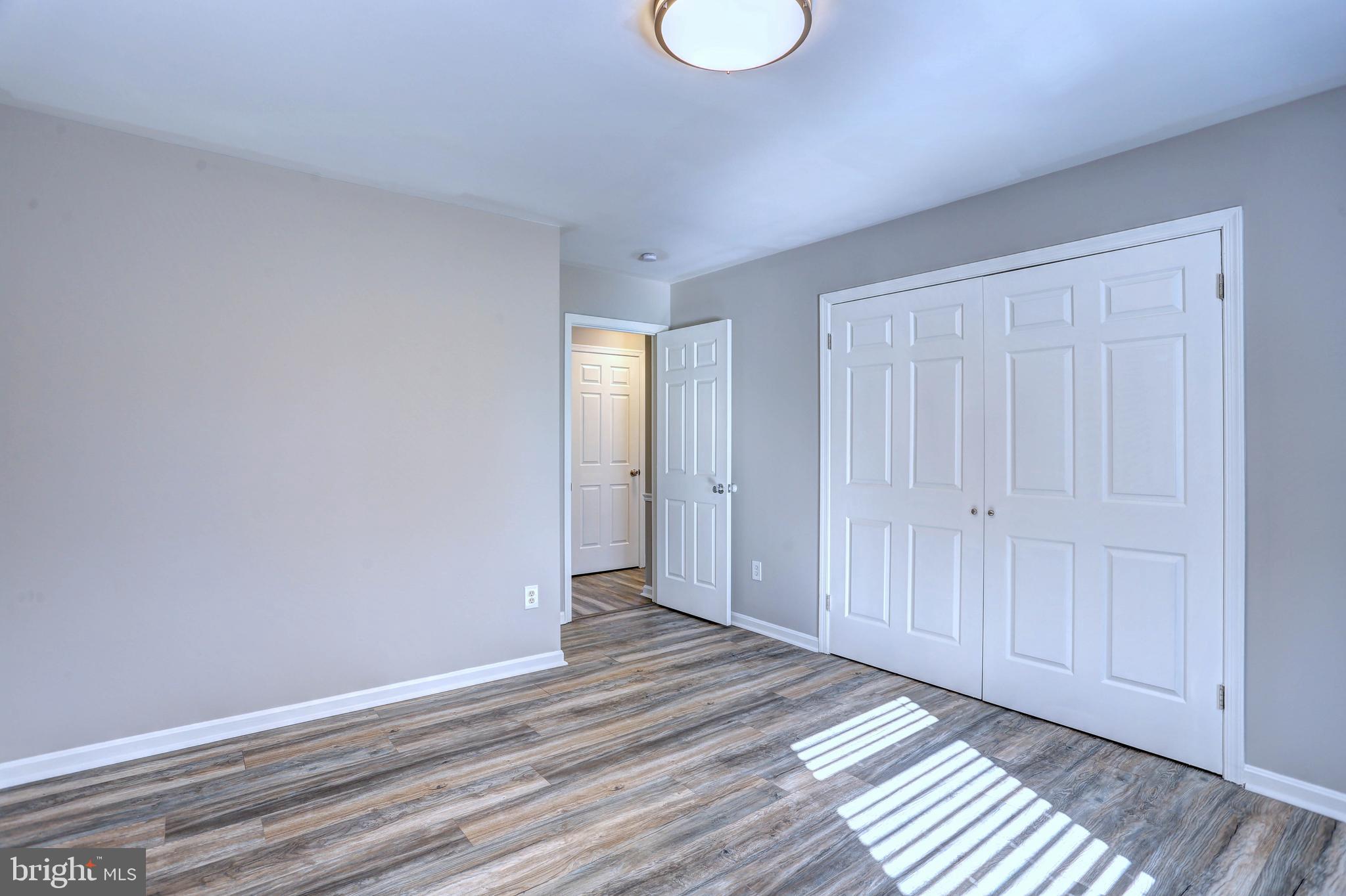 9575 Cissell Avenue Laurel, MD 20723 - Photo 11 of 34 a view of a room with wooden floor and bathroom