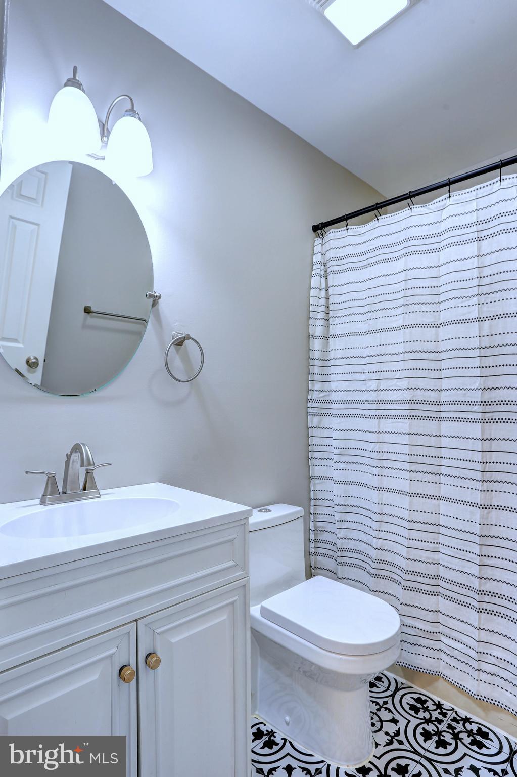 9575 Cissell Avenue Laurel, MD 20723 - Photo 12 of 34 a bathroom with a sink a toilet and mirror