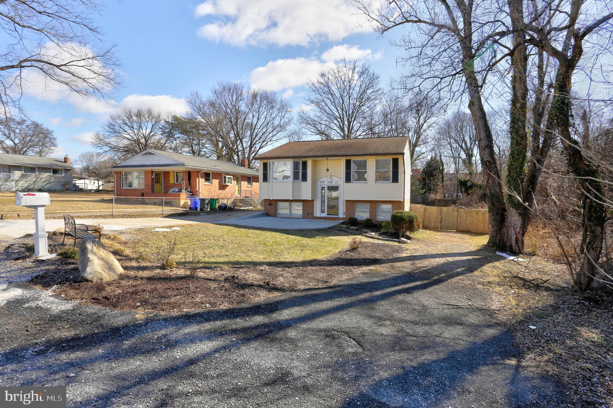 9575 Cissell Avenue Laurel, MD 20723 - Photo 28 of 34 a view of a white house with a big yard and large trees