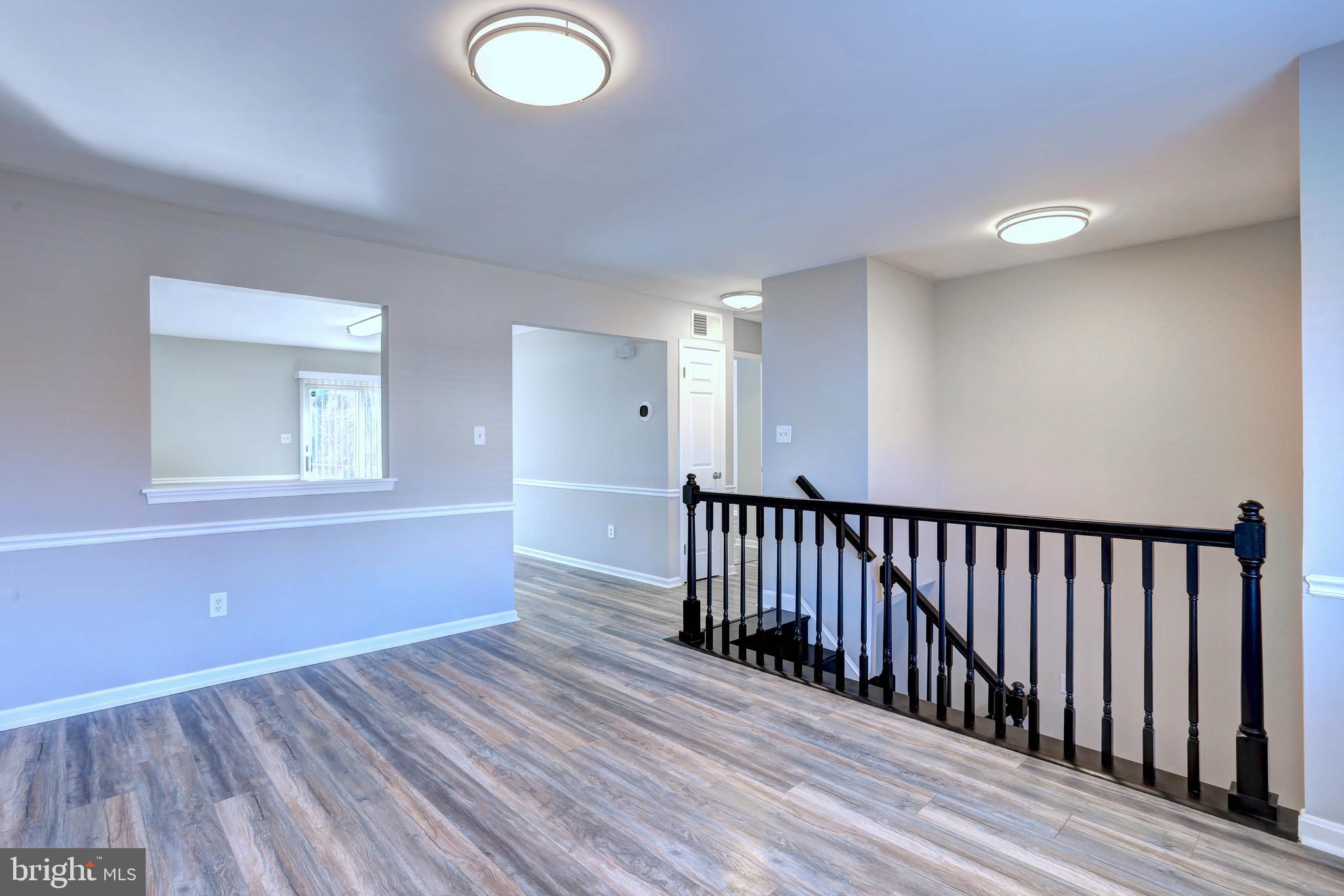 9575 Cissell Avenue Laurel, MD 20723 - Photo 3 of 34 a view of a livingroom with wooden floor