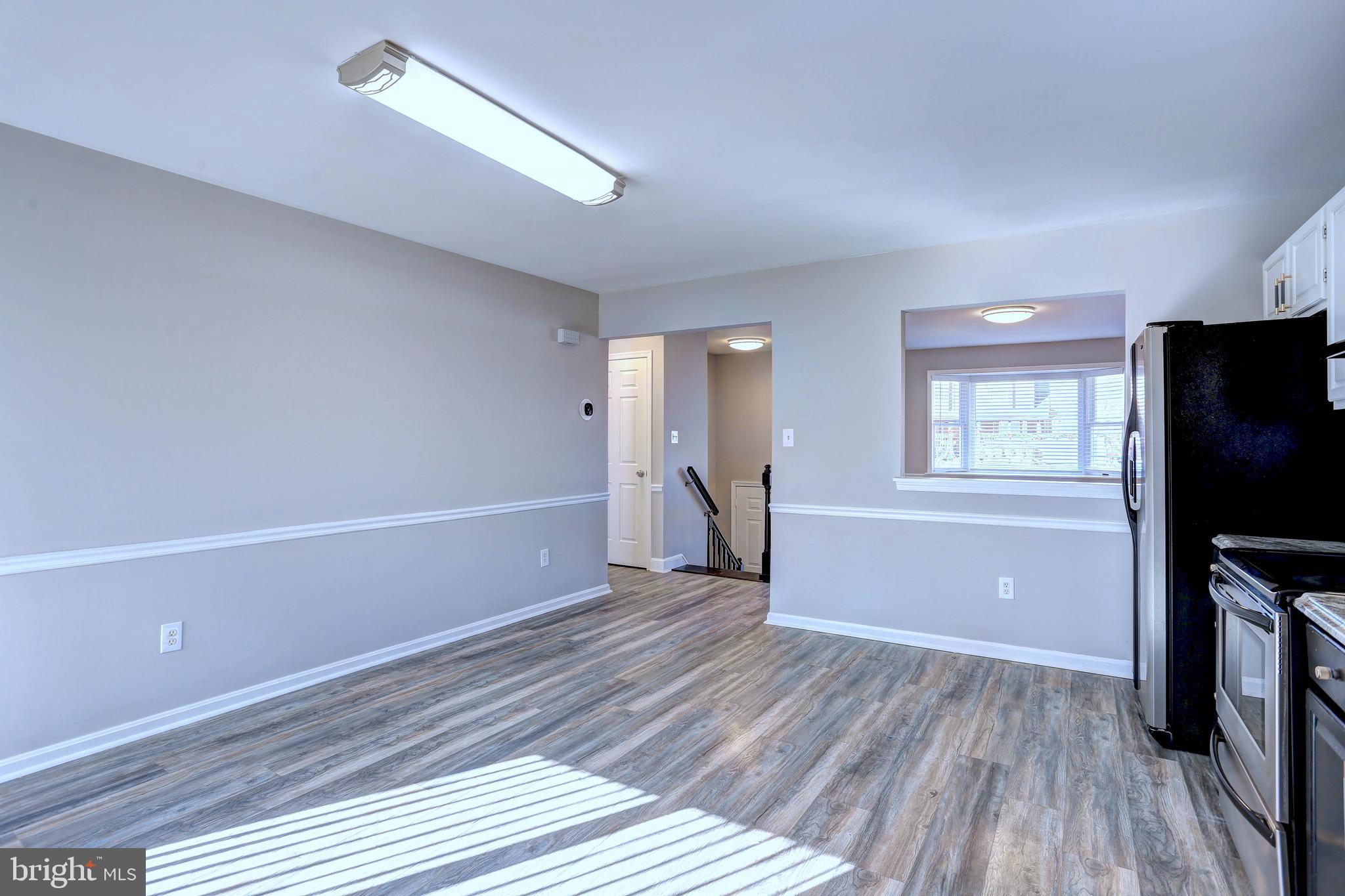 9575 Cissell Avenue Laurel, MD 20723 - Photo 8 of 34 a view of a livingroom with wooden floor and a flat screen tv