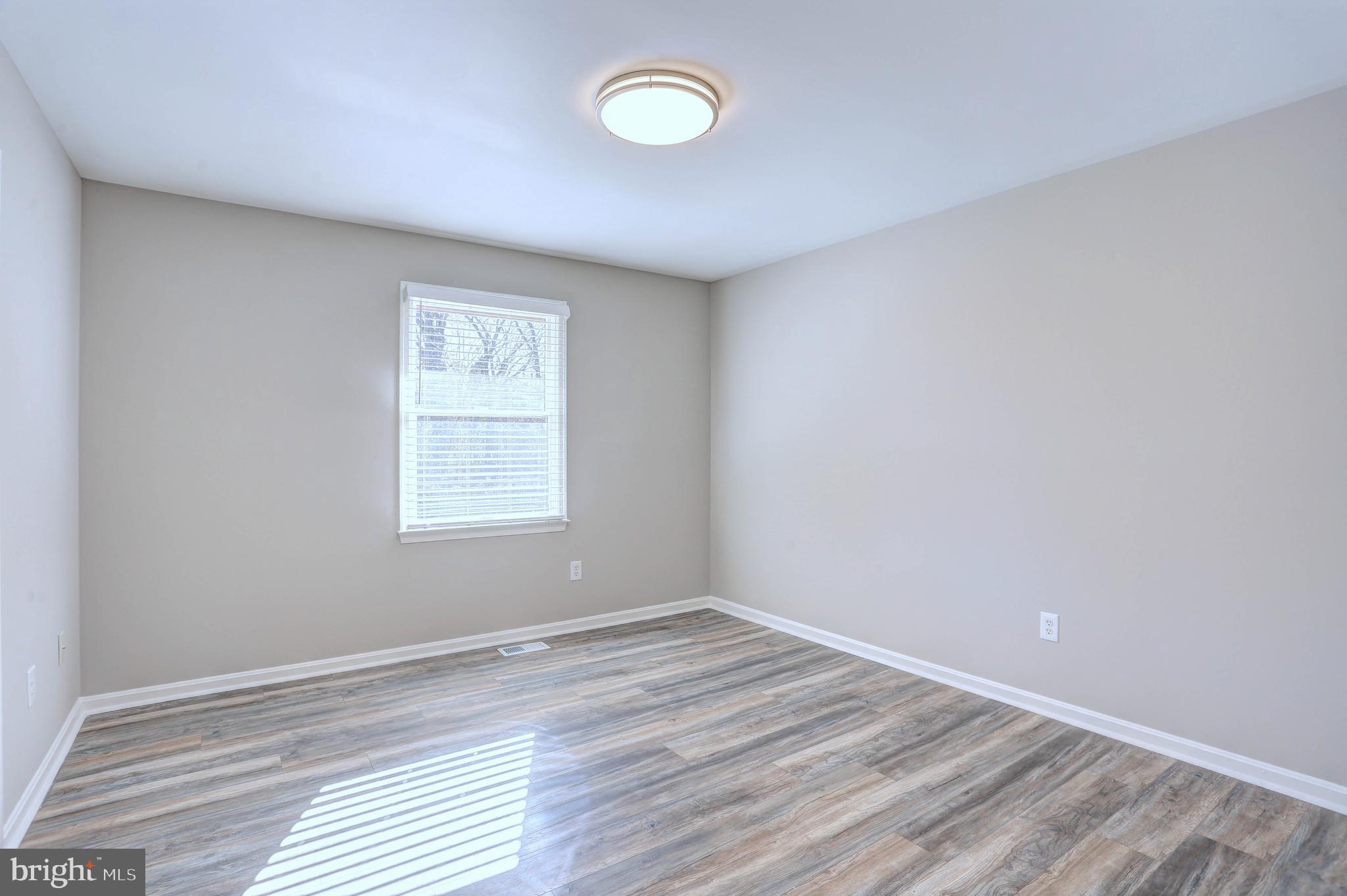9575 Cissell Avenue Laurel, MD 20723 - Photo 10 of 34 wooden floor in an empty room with a window