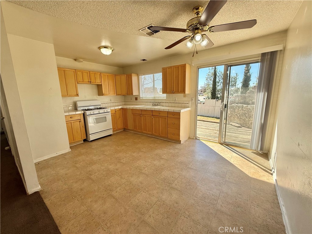 9920 Jurupa Road Jurupa Valley, CA 92509 - Photo 3 of 13 a large kitchen with a stove a sink and dishwasher