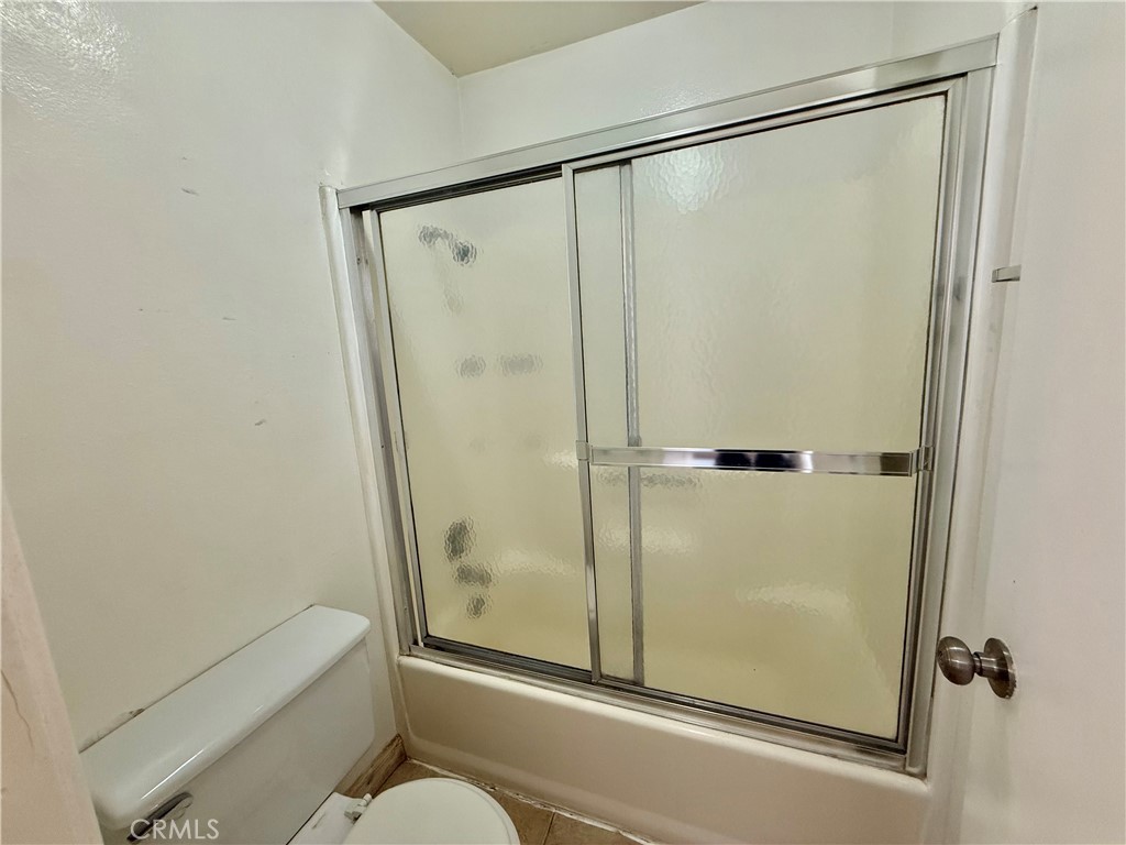 9920 Jurupa Road Jurupa Valley, CA 92509 - Photo 6 of 13 a bathroom with a shower and a glass door