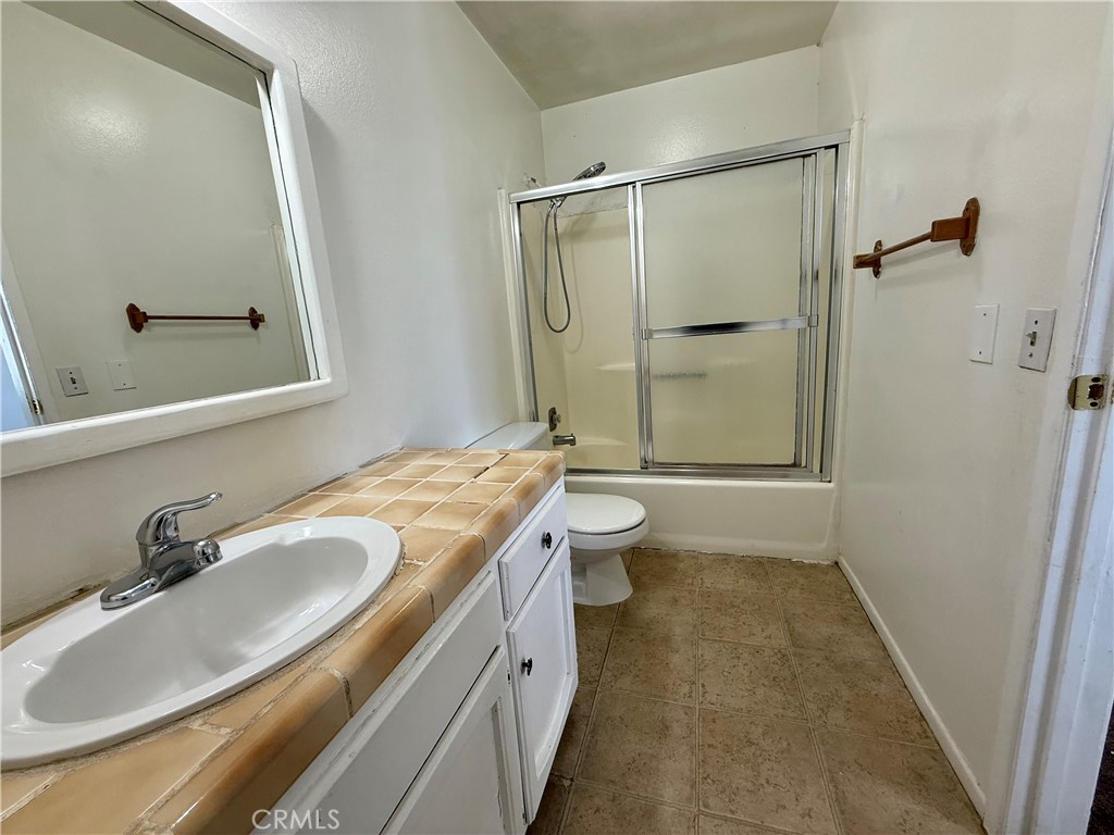 9920 Jurupa Road Jurupa Valley, CA 92509 - Photo 8 of 13 a bathroom with a sink and a mirror
