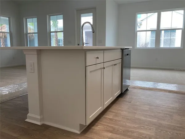 a bathroom with a granite countertop sink a toilet and shower