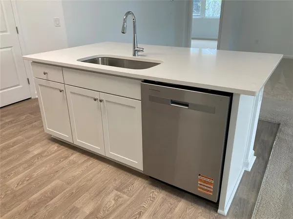 a view of a livingroom and an empty room