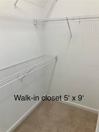 a view of a chair and table in backyard of the house