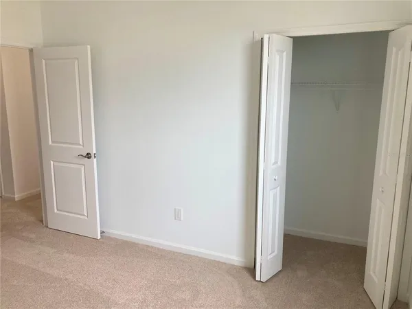 a view of a patio with a table and chairs under an umbrella