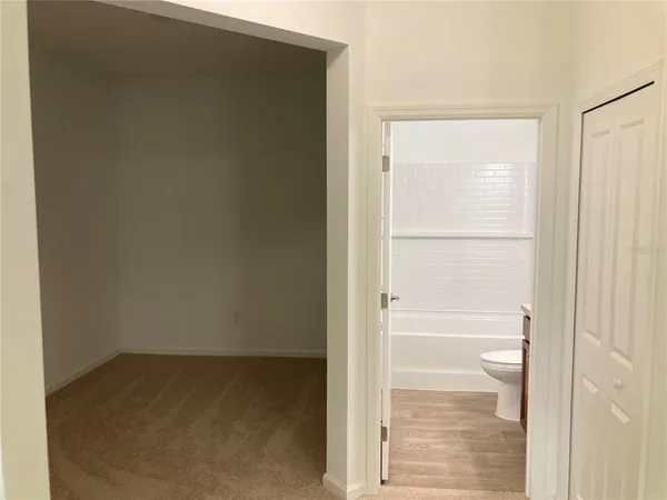 a view of a brick house with a wooden fence