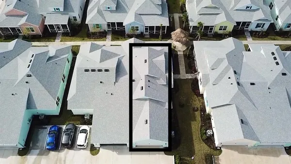 an aerial view of a house with a yard