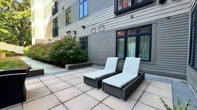 a table and chairs sitting in front of a house