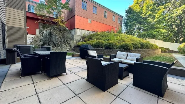 a living room with furniture gym equipment and a rug