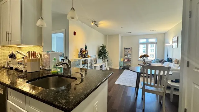 a kitchen with sink and view living room