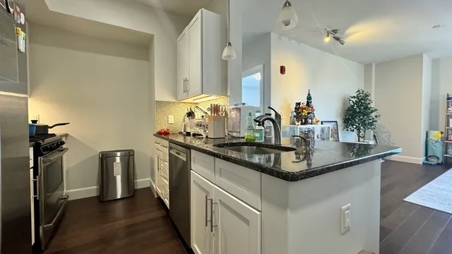 a kitchen with stainless steel appliances granite countertop a sink and stove