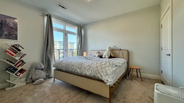 a bed sitting in a bedroom next to a window