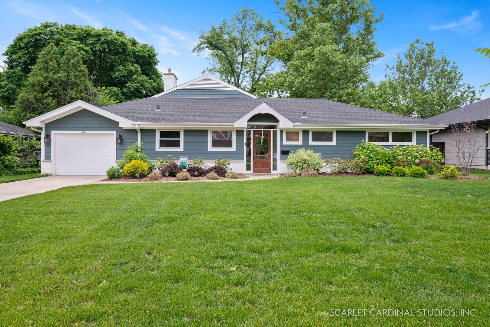 a front view of house with yard and green space
