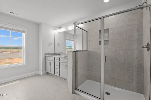 a bathroom with a shower and a sink