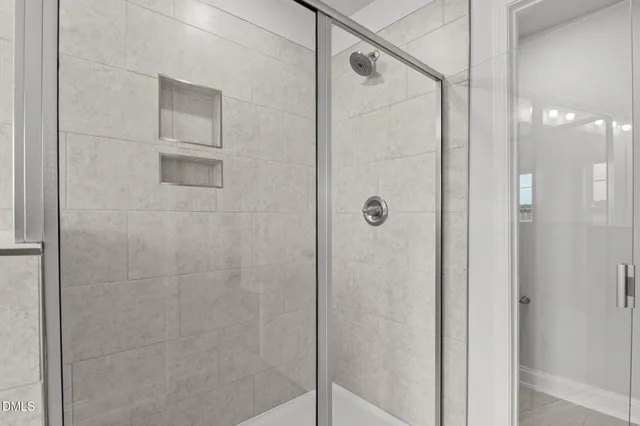 a bathroom with a glass shower door