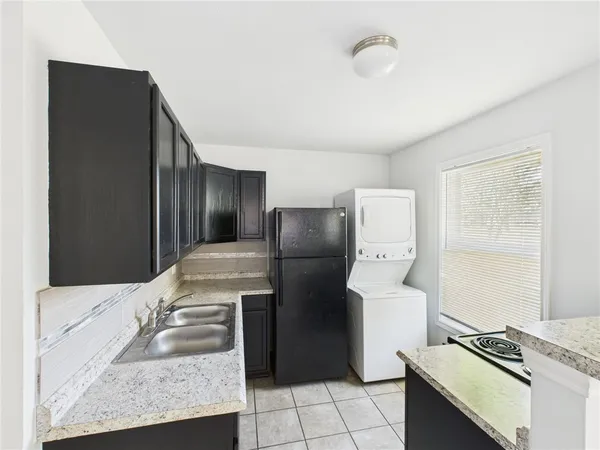 a kitchen with a refrigerator and a stove