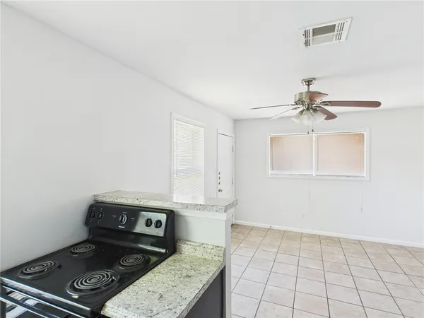 a view of a storage & utility room with a fridge
