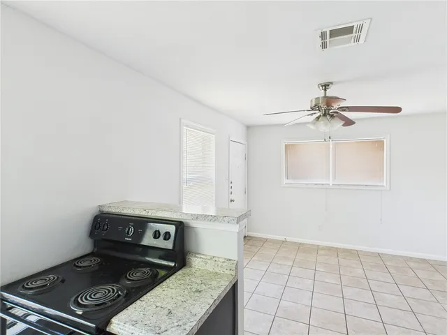 a view of a storage & utility room with a fridge