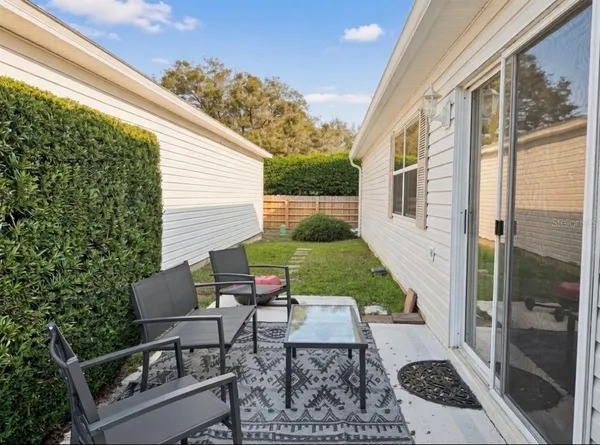 a view of backyard with outdoor seating