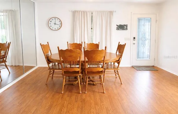a dining room with furniture and wooden floor