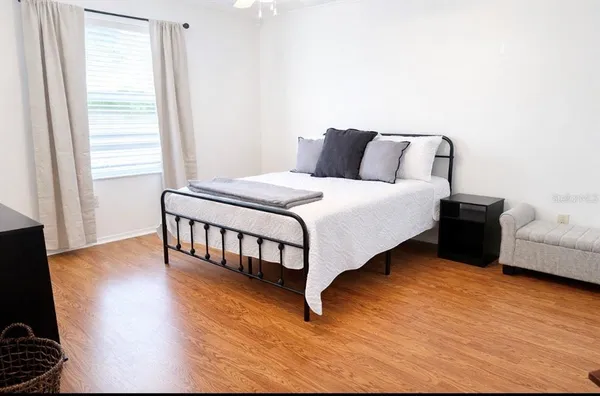 a bedroom with bed and a window