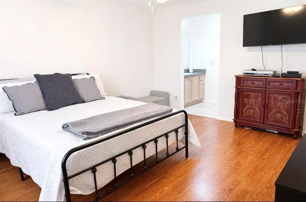 a bedroom with a bed and flat screen tv