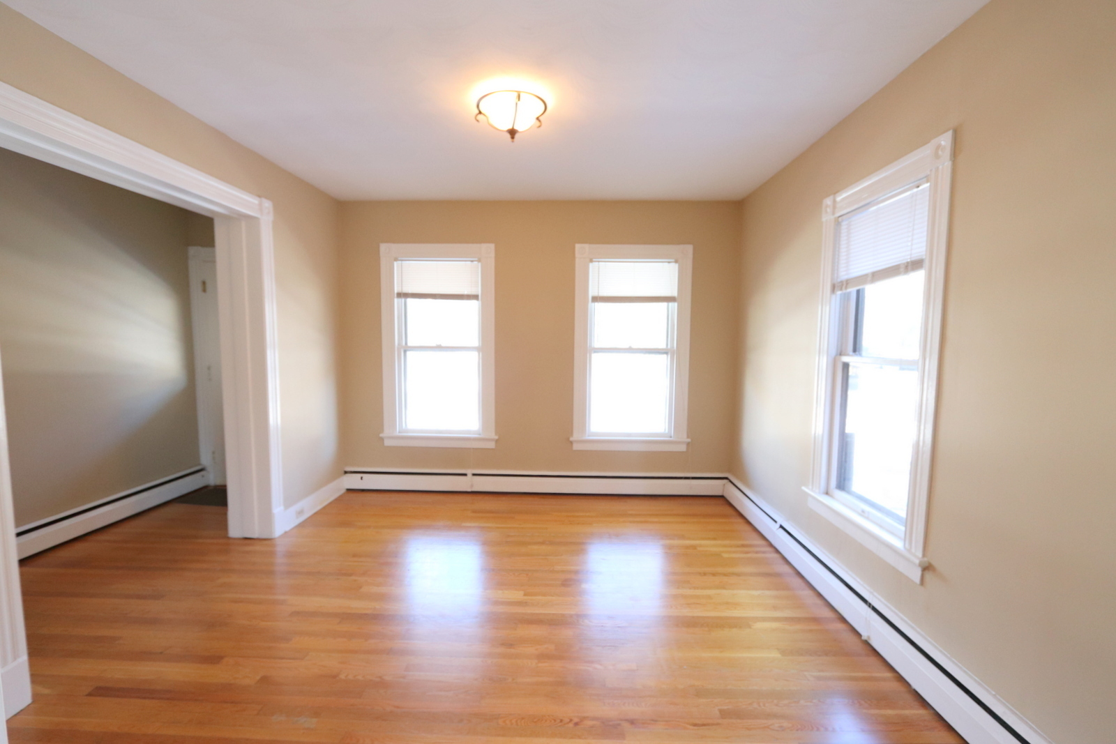 72 North Whittlesey Avenue, Unit 1 Wallingford, CT 06492 - Photo 5 of 11 an empty room with wooden floor and windows