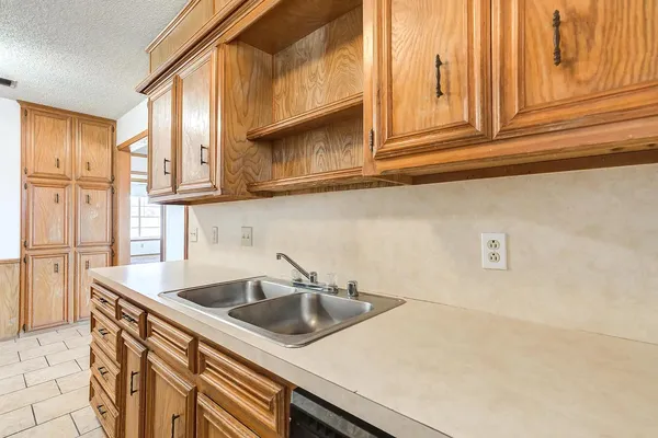 a kitchen with stainless steel appliances granite countertop a sink and a white cabinets