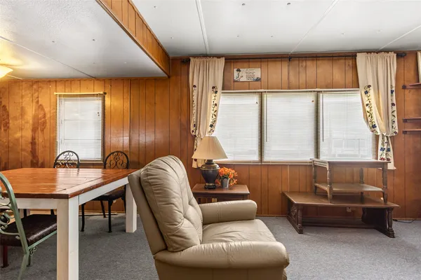 a livingroom with furniture and a large window