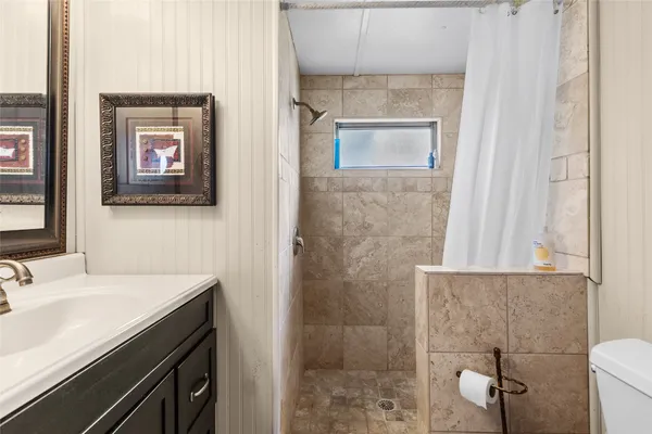 a bathroom with a sink a mirror and a shower