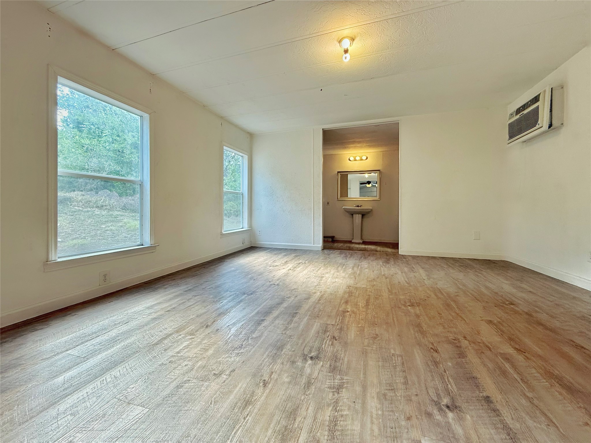 10601 Ridge Rim Drive Leander, TX 78641 - Photo 19 of 35 Generous windows invite natural light to sweep across the enduring wood-look flooring.
