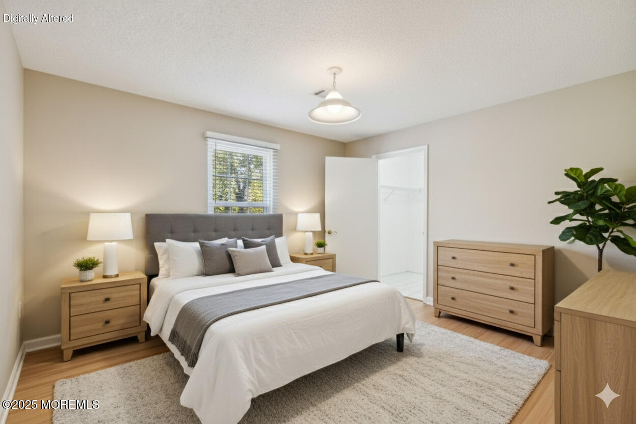 20-3 Austin Court, Unit 7 Freehold, NJ 07728 - Photo 15 of 31 a bedroom with a bed and a dresser