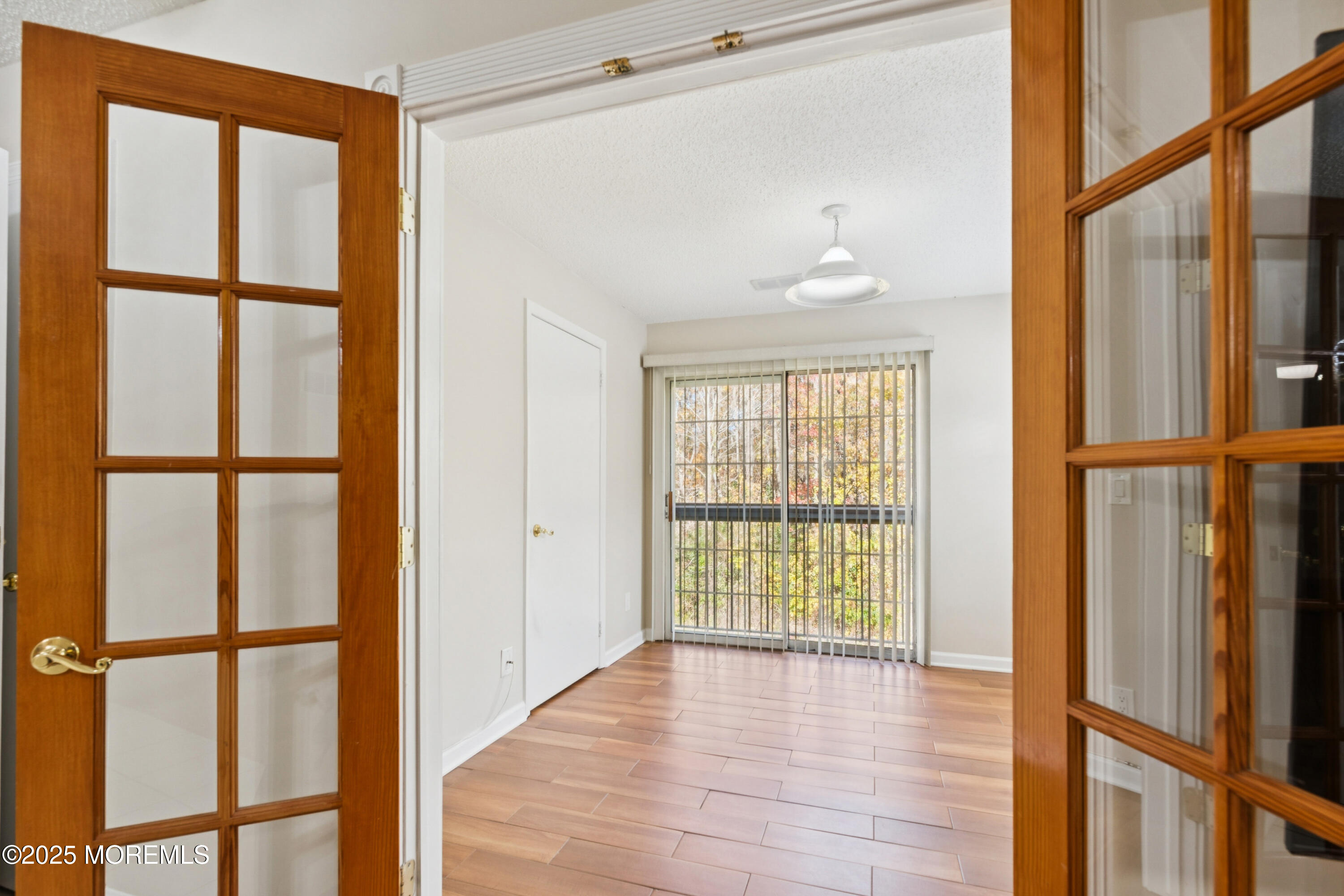 20-3 Austin Court, Unit 7 Freehold, NJ 07728 - Photo 2 of 31 a view of an empty room with a window and wooden floor
