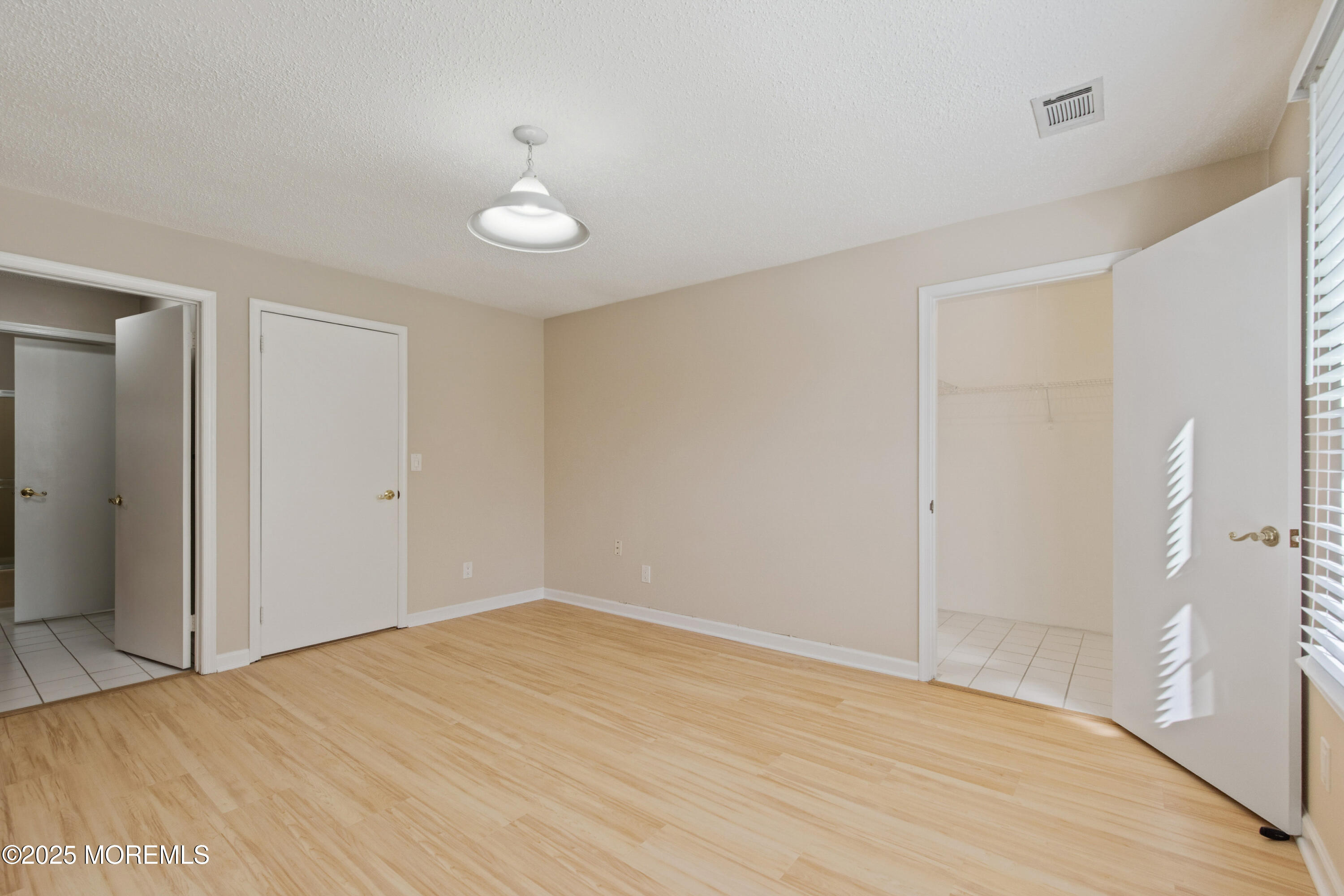 20-3 Austin Court, Unit 7 Freehold, NJ 07728 - Photo 22 of 31 a view of empty room with wooden floor