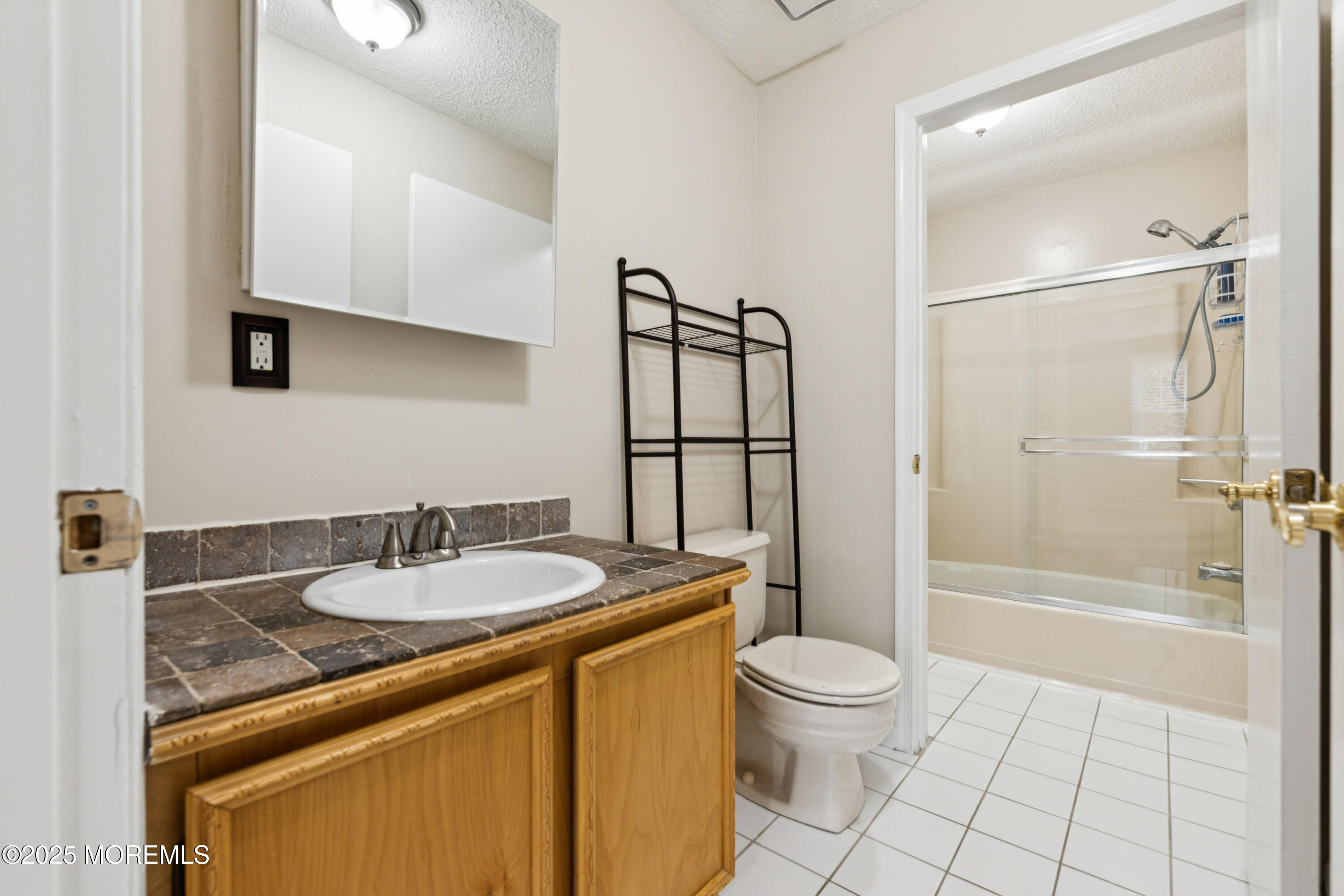 20-3 Austin Court, Unit 7 Freehold, NJ 07728 - Photo 26 of 31 a bathroom with a granite countertop sink toilet and shower